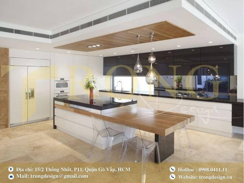 Thiết kế bếp chữ L với đảo bếp trung tâm tích hợp bàn ăn. 