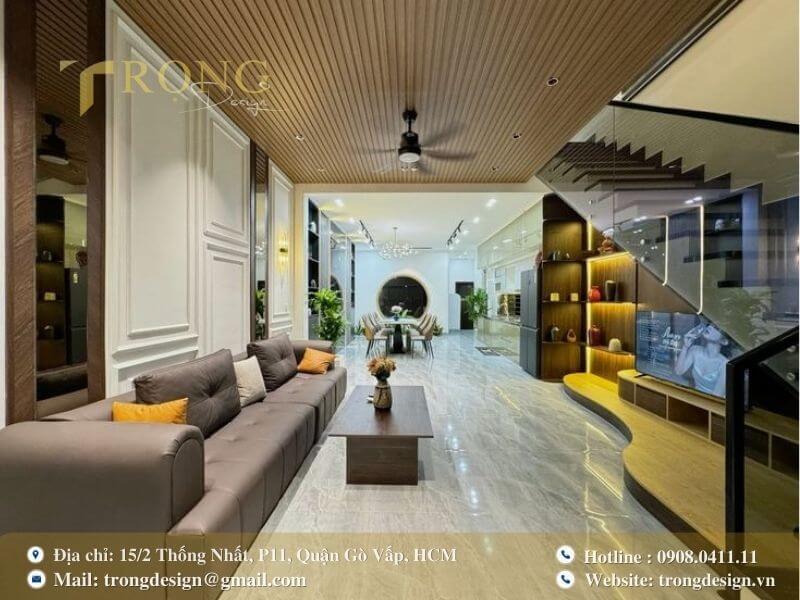 Phòng khách hiện đại, ấm cúng với trần gỗ và chi tiết cong mềm mại.